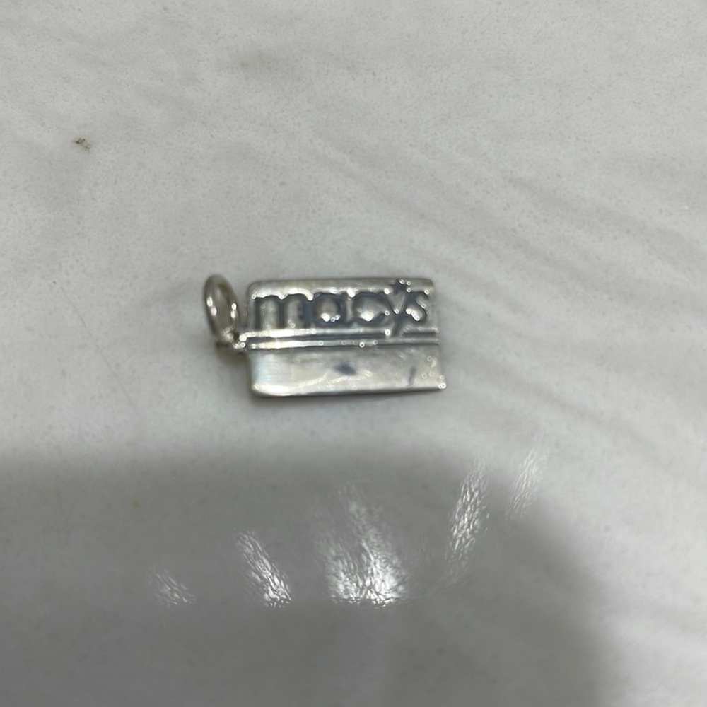Macy’s charm- sterling silver